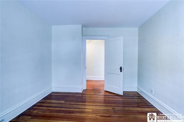 unfurnished room with dark hardwood / wood-style floors