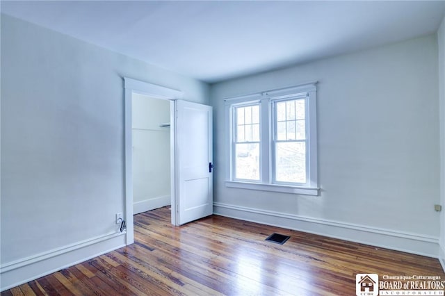 unfurnished room featuring wood-type flooring