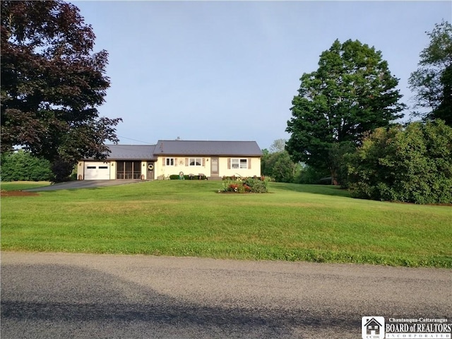 view of front facade with a front yard and a garage