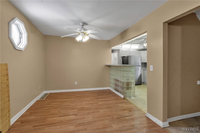 interior space featuring ceiling fan and light hardwood / wood-style flooring