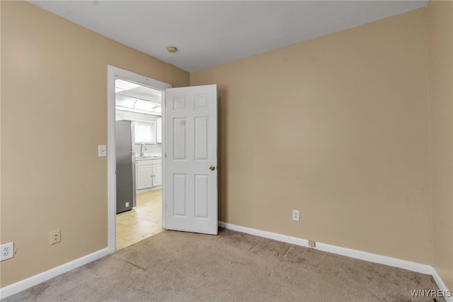 carpeted empty room featuring sink