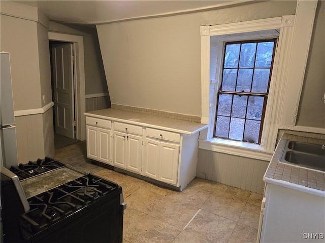 kitchen with white cabinets and black gas range