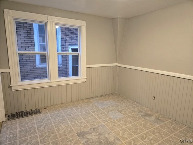 empty room featuring wooden walls