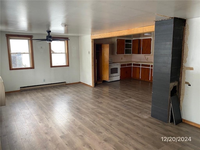 unfurnished living room with ceiling fan, a baseboard radiator, and wood-type flooring