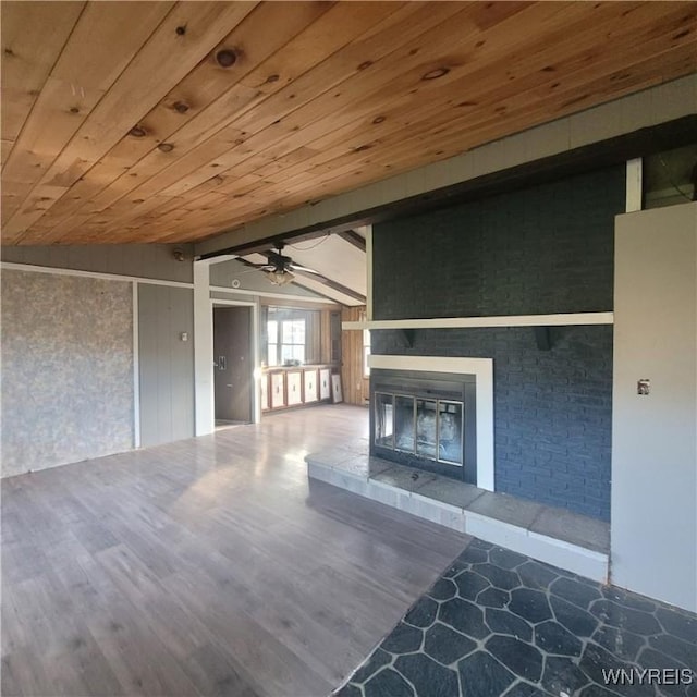 unfurnished living room with hardwood / wood-style flooring, vaulted ceiling, ceiling fan, and wood ceiling