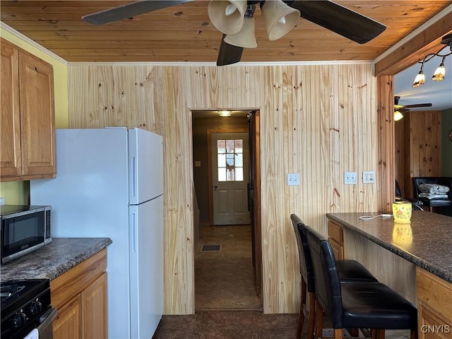 kitchen with hanging light fixtures, dark colored carpet, black electric range, wooden walls, and wood ceiling