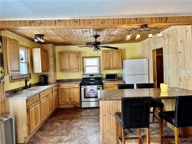 kitchen with sink, a kitchen island, a kitchen bar, and stainless steel appliances