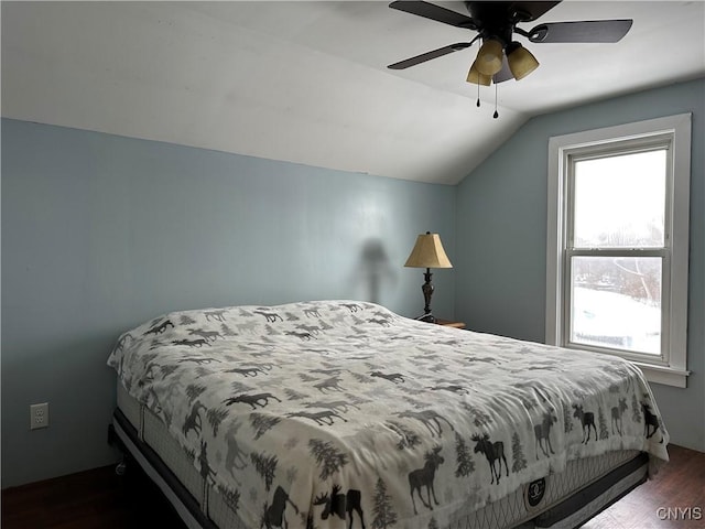 bedroom featuring ceiling fan, dark hardwood / wood-style flooring, and vaulted ceiling