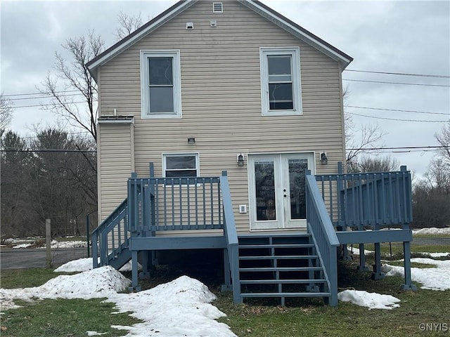 snow covered house featuring a deck