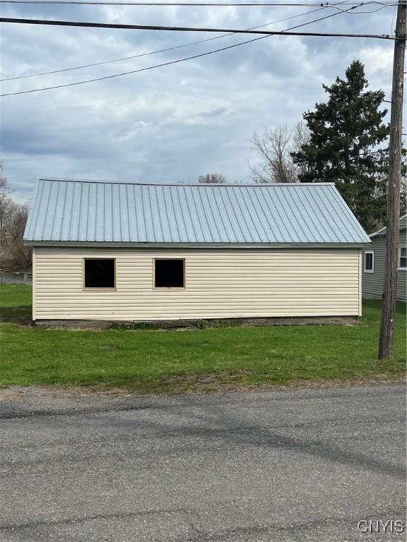 57 Liberty St, Adams, NY 13605 - view of property exterior featuring metal roof