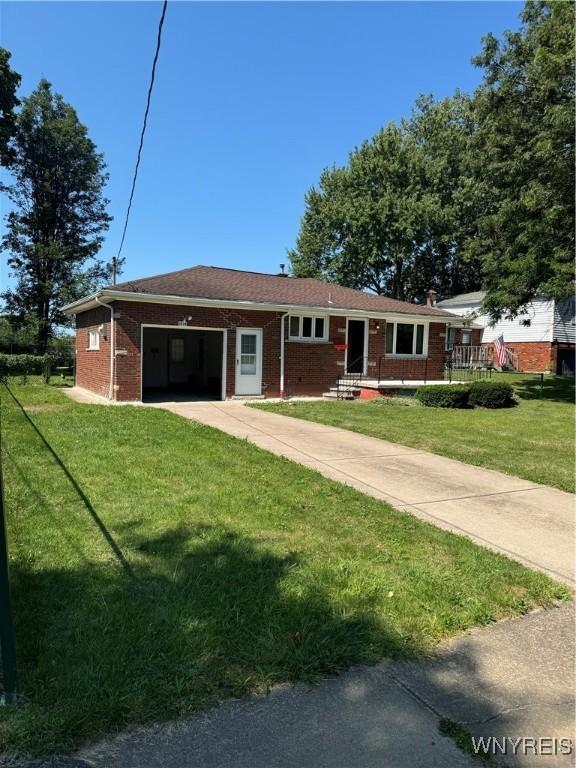 ranch-style house with a garage and a front lawn