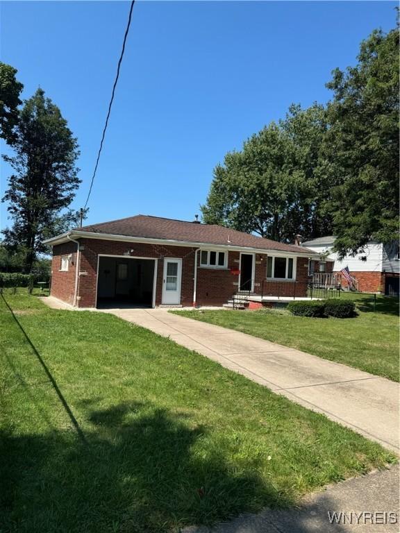 ranch-style house with a front yard and a garage