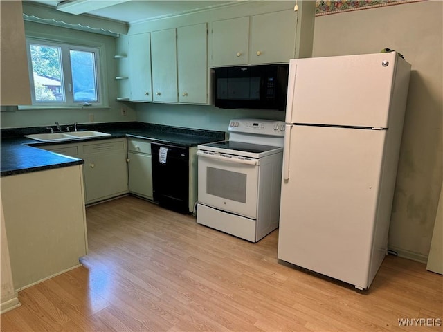 kitchen featuring sink, green cabinets, beamed ceiling, black appliances, and light wood-type flooring