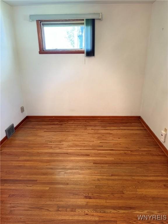 empty room featuring wood-type flooring