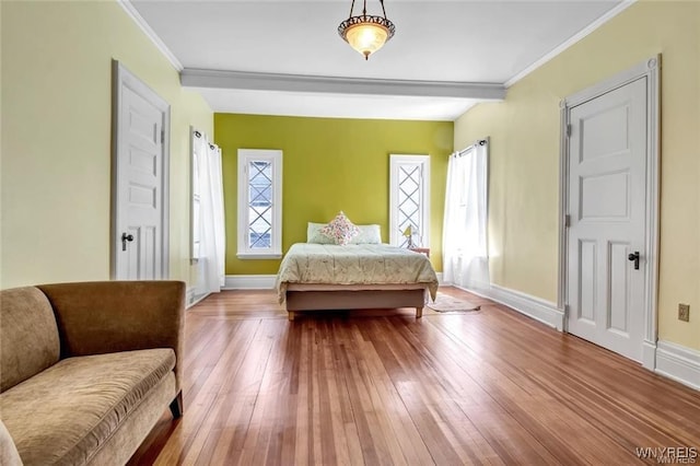 bedroom with wood-type flooring and ornamental molding