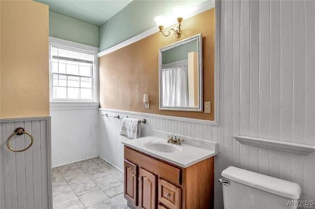 bathroom with tile patterned flooring, vanity, and toilet