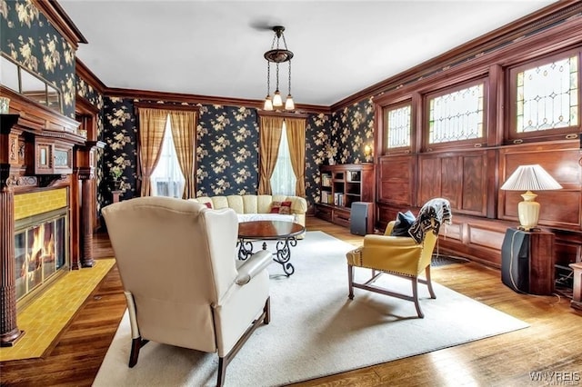 sitting room with crown molding and hardwood / wood-style flooring