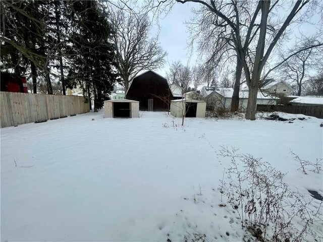 yard covered in snow with an outdoor structure