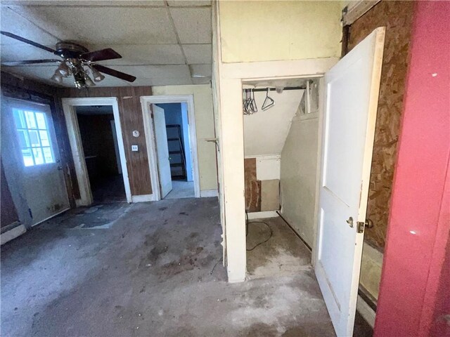 interior space featuring ceiling fan and concrete floors