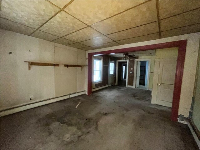 misc room with ceiling fan and a baseboard heating unit