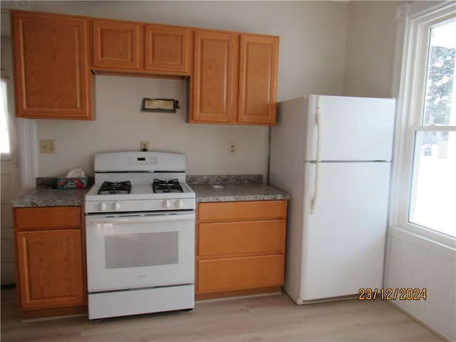 kitchen featuring white appliances and light wood-type flooring