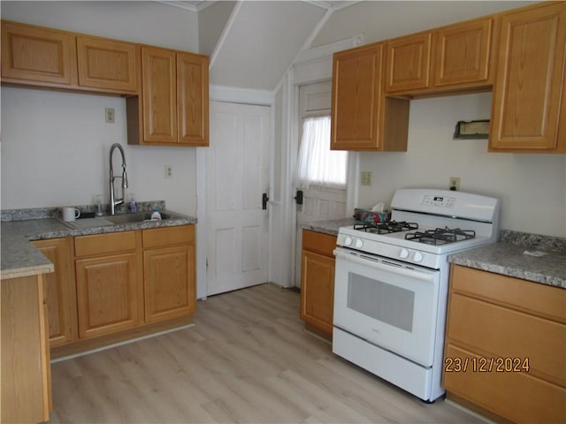 kitchen featuring sink, white range with gas cooktop, and light hardwood / wood-style flooring