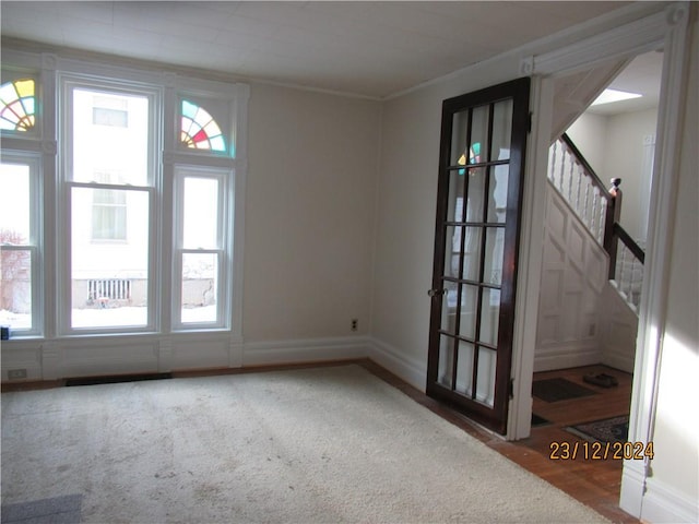 unfurnished room with crown molding