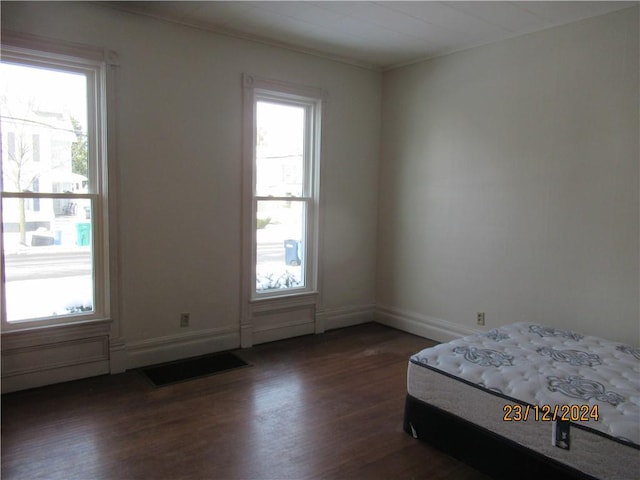 unfurnished bedroom with dark hardwood / wood-style floors