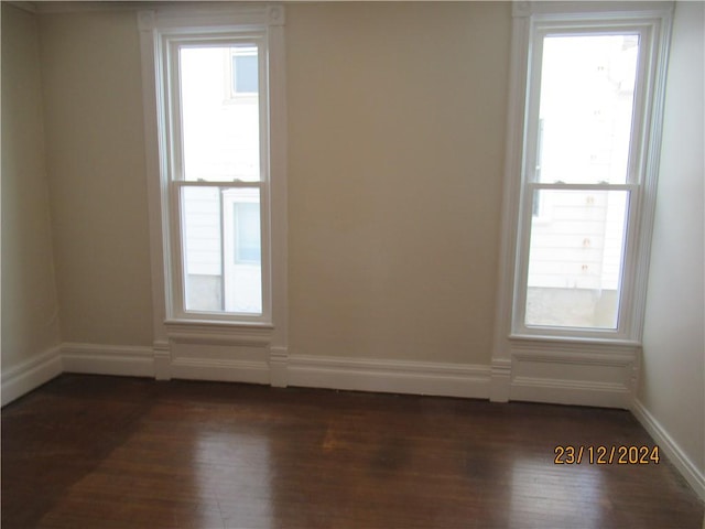 spare room featuring dark hardwood / wood-style floors