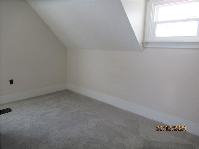 bonus room with carpet floors and lofted ceiling