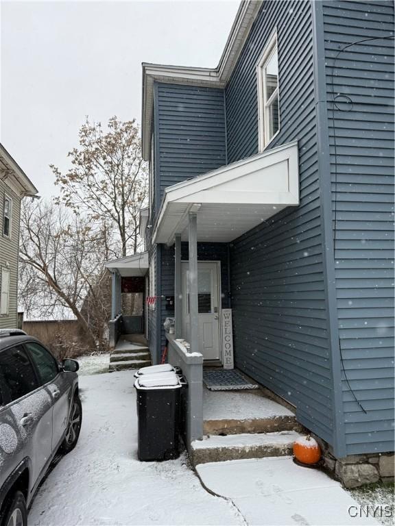 view of snow covered property entrance