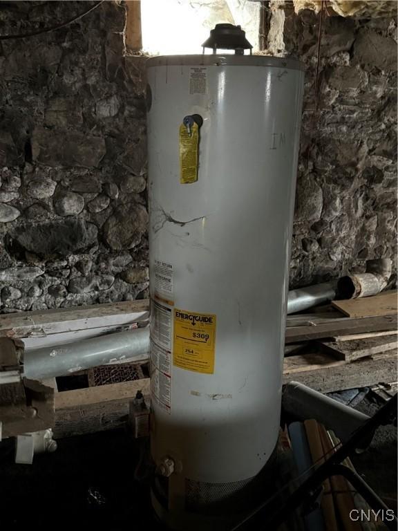 utility room featuring water heater