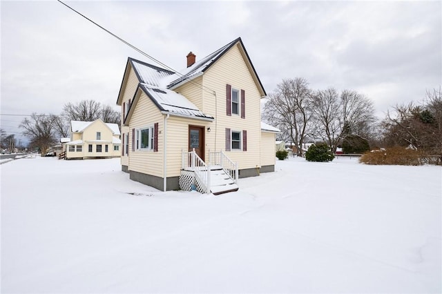 view of snow covered back of property