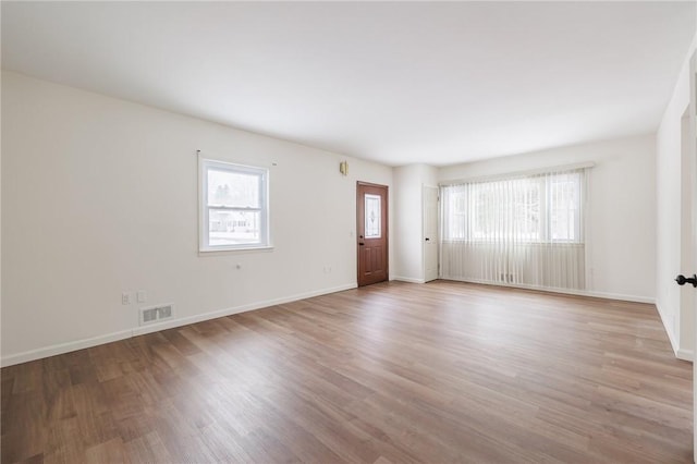 empty room with light hardwood / wood-style flooring