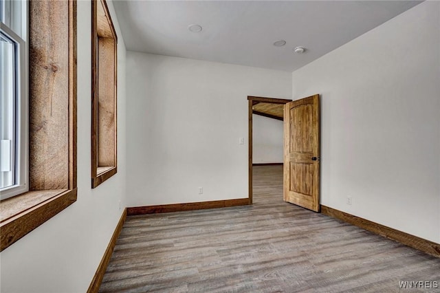 unfurnished room with light hardwood / wood-style floors