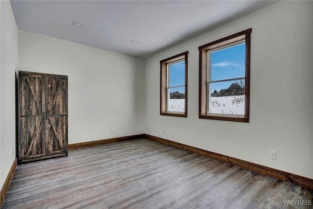 spare room featuring light hardwood / wood-style flooring