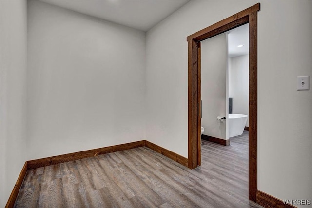 unfurnished room with hardwood / wood-style flooring