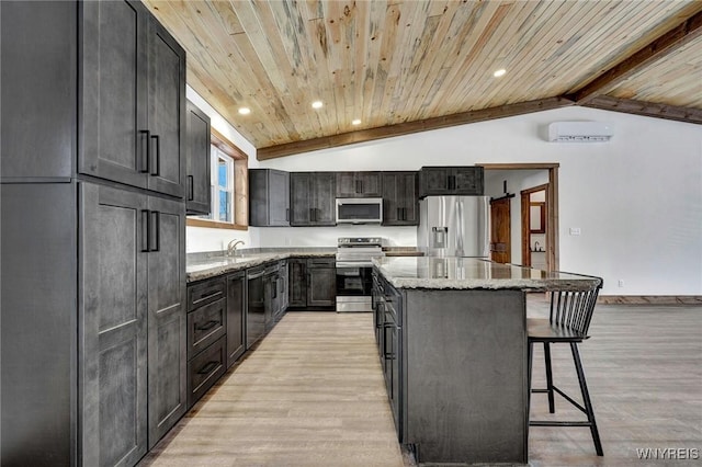 kitchen featuring appliances with stainless steel finishes, a center island, light stone counters, and wooden ceiling