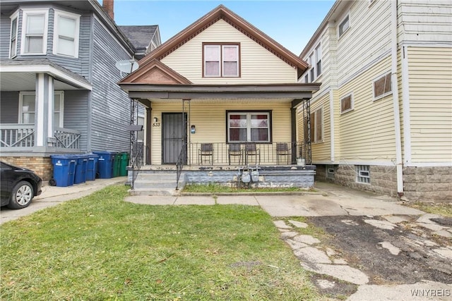 view of front of home with covered porch and a front yard