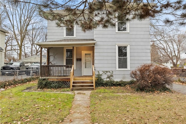 view of front of home featuring a front yard and a porch