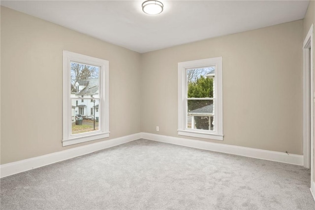 empty room with carpet floors and plenty of natural light