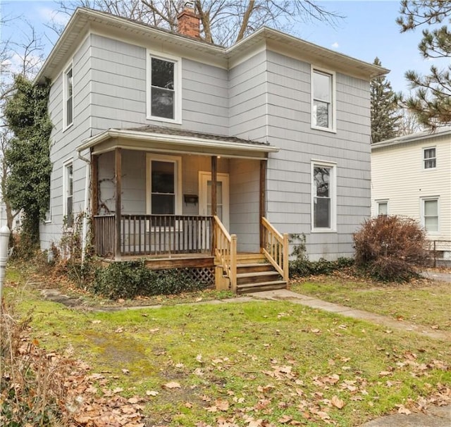 view of front property with a porch and a front yard