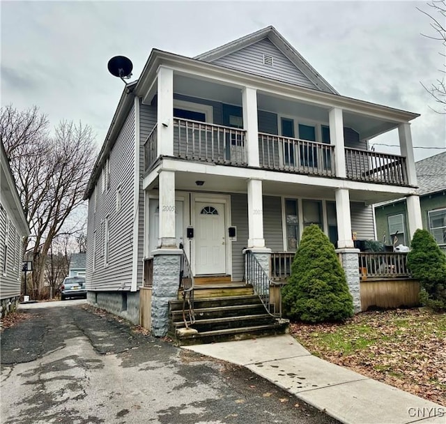 view of front of house with a balcony and covered porch