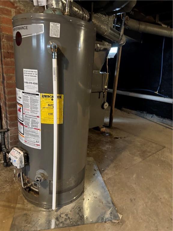 utility room featuring water heater