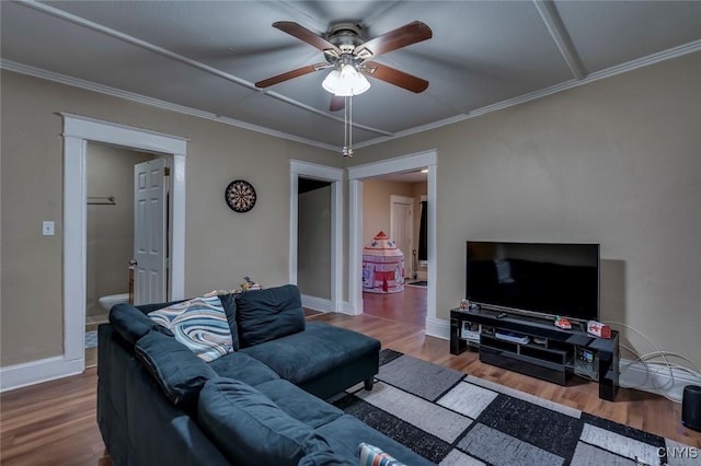 living room with wood-type flooring, ceiling fan, and crown molding