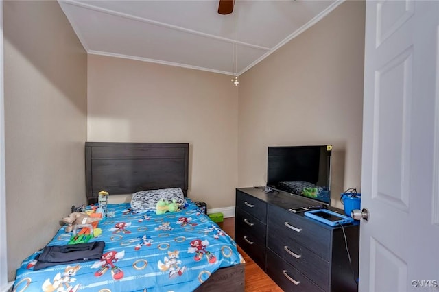 bedroom featuring ceiling fan, wood-type flooring, and ornamental molding