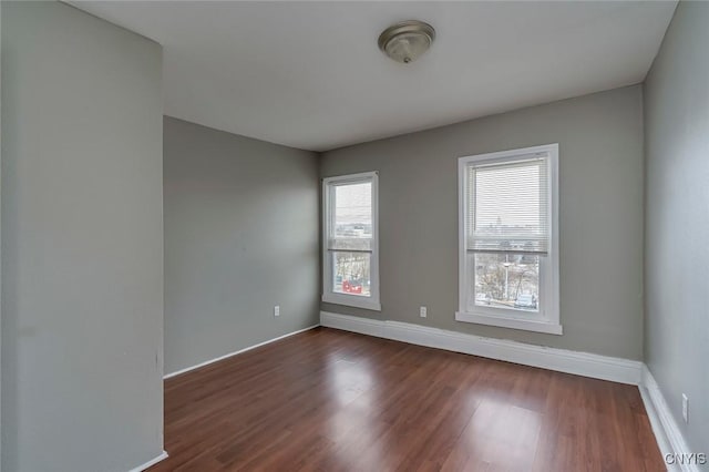 empty room with dark wood-type flooring