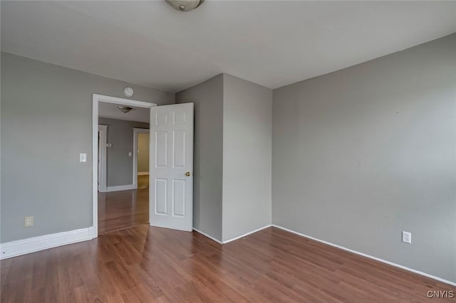 empty room with hardwood / wood-style floors