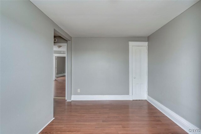 spare room featuring dark wood-type flooring