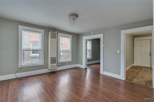 unfurnished room featuring dark hardwood / wood-style flooring